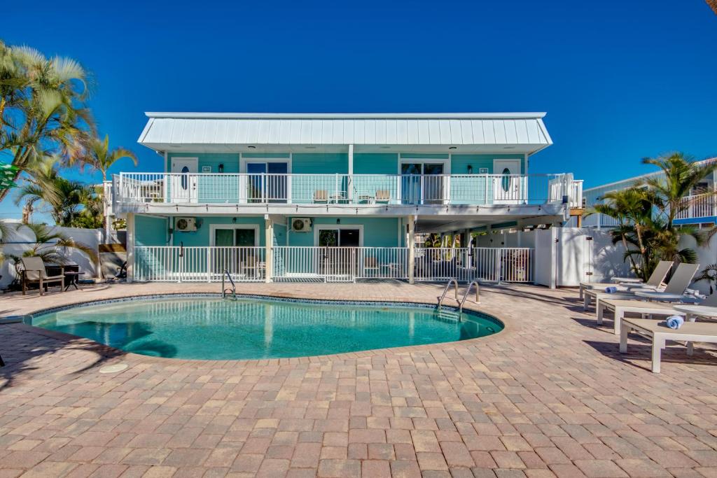 a house with a swimming pool in front of a house at Sand Dollar 1 in Fort Myers Beach