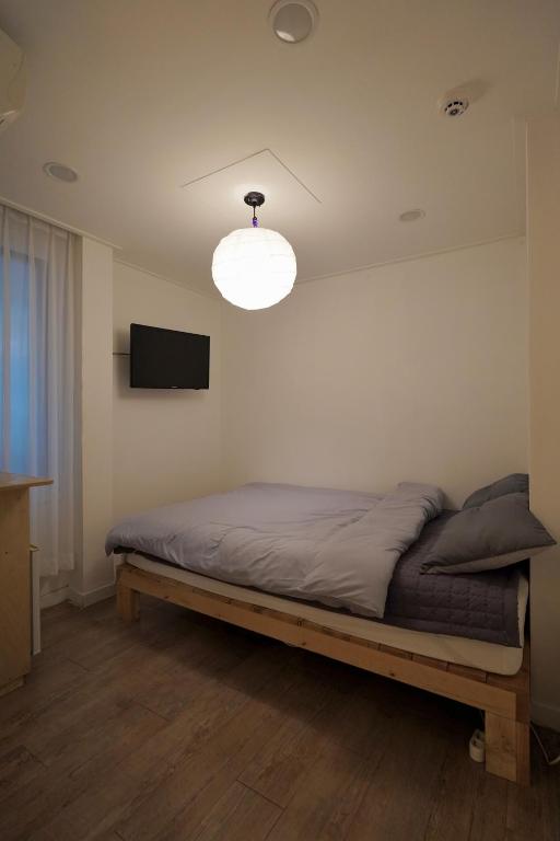 Postel nebo postele na pokoji v ubytování Soo Guest House