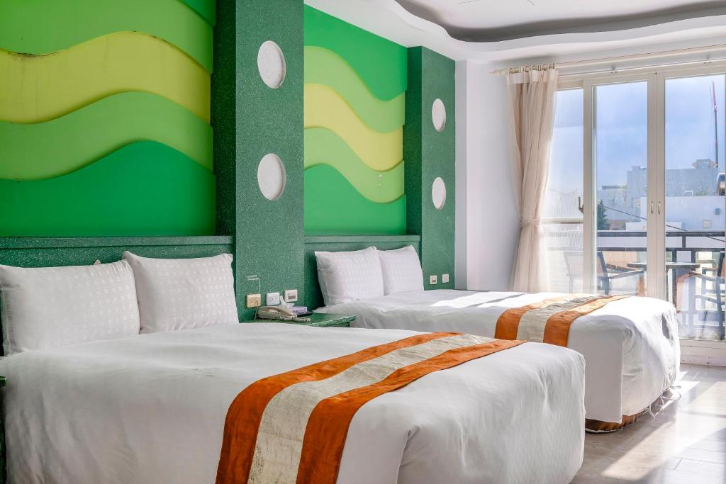 Postel nebo postele na pokoji v ubytování Wei Yuan Hotel