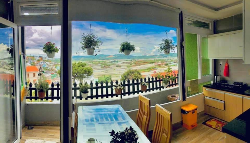 a dining room with a large window with a view at Horizon Homestay in Ấp Kim Thạch