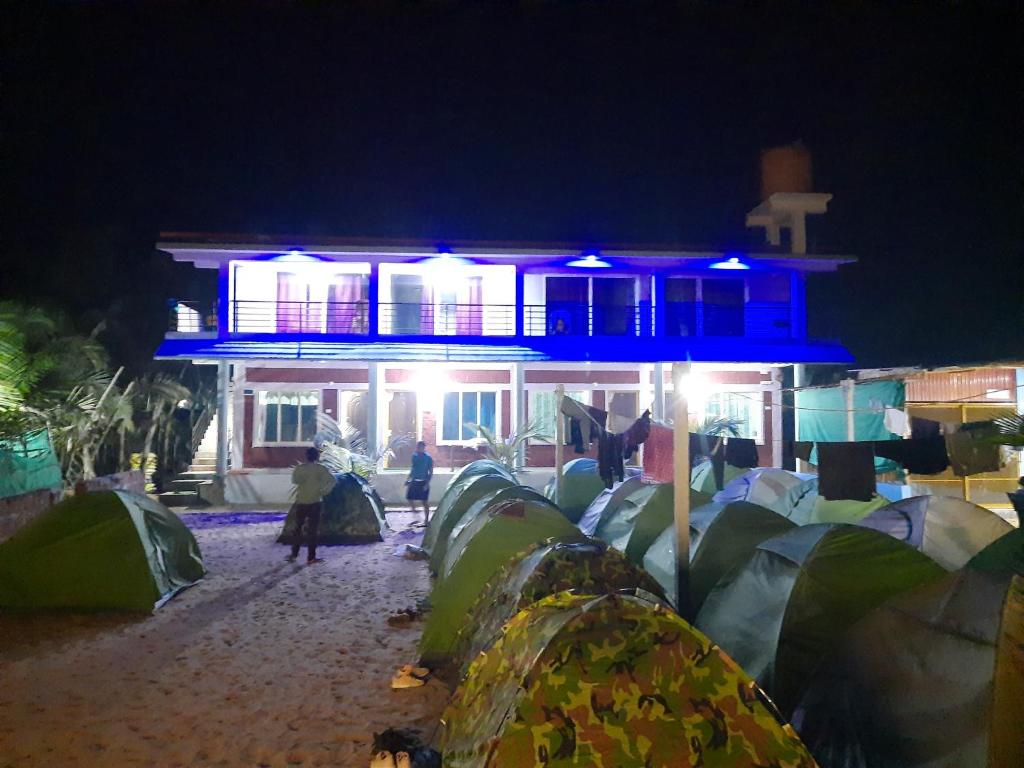 a group of tents in front of a building at night at Gokarna Govekar Sea Facing Rooms in Gokarn