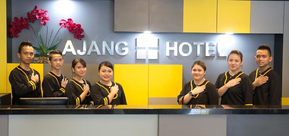 a group of people standing in front of a hotel at Ajang Hotel in Miri