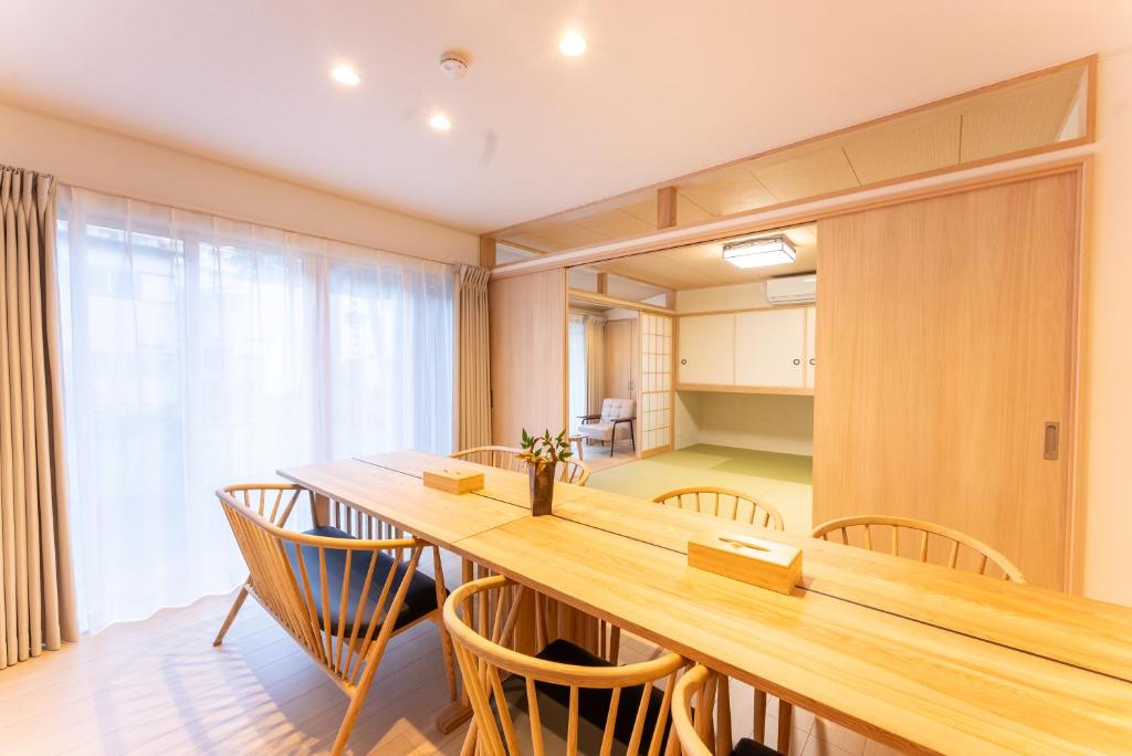 une salle à manger avec une longue table et des chaises dans l'établissement Stagione Hakone Yumoto Villa スタジオーネ箱根湯本VILLA, à Hakone