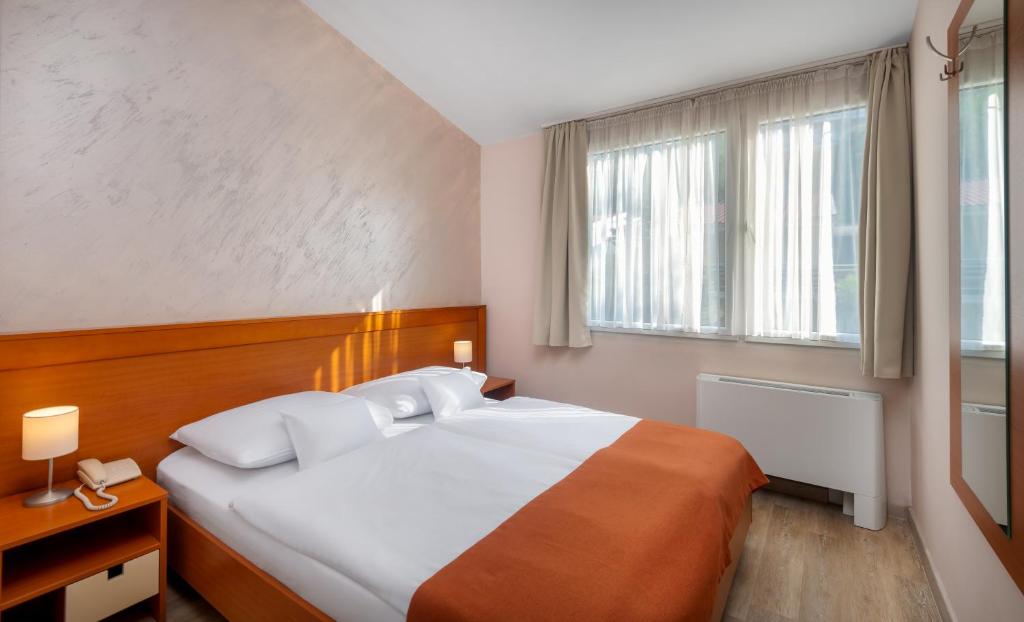Postel nebo postele na pokoji v ubytování Hunguest Hotel Sun Resort