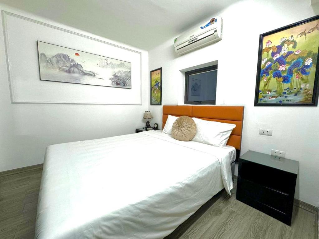 Postel nebo postele na pokoji v ubytování Hanoi Elpis Hotel