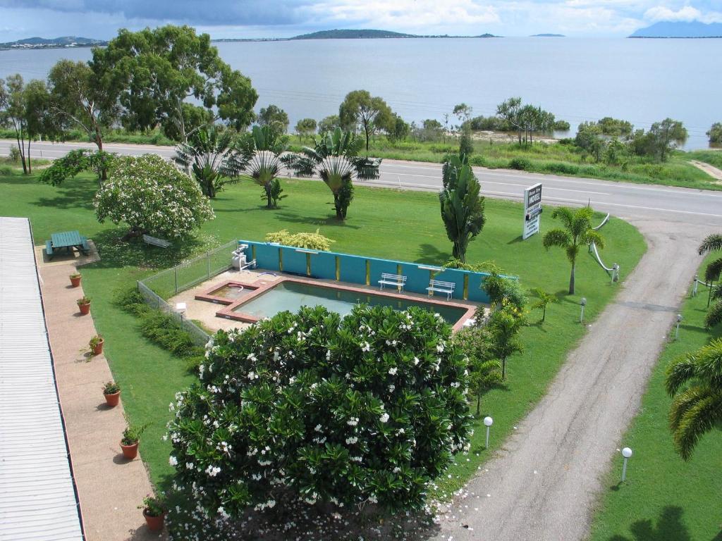 an aerial view of a park with a swimming pool at Ocean View Motel Bowen in Bowen