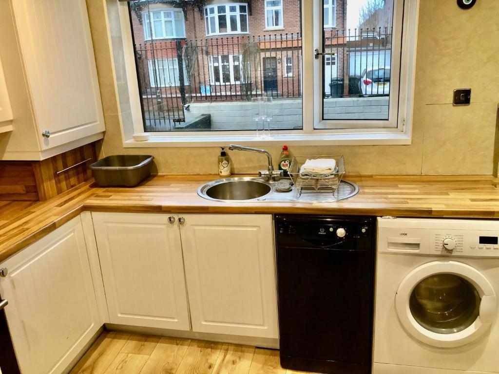 a kitchen with a sink and a washing machine at Two the Manor Born 3 bedroom house in Tynemouth