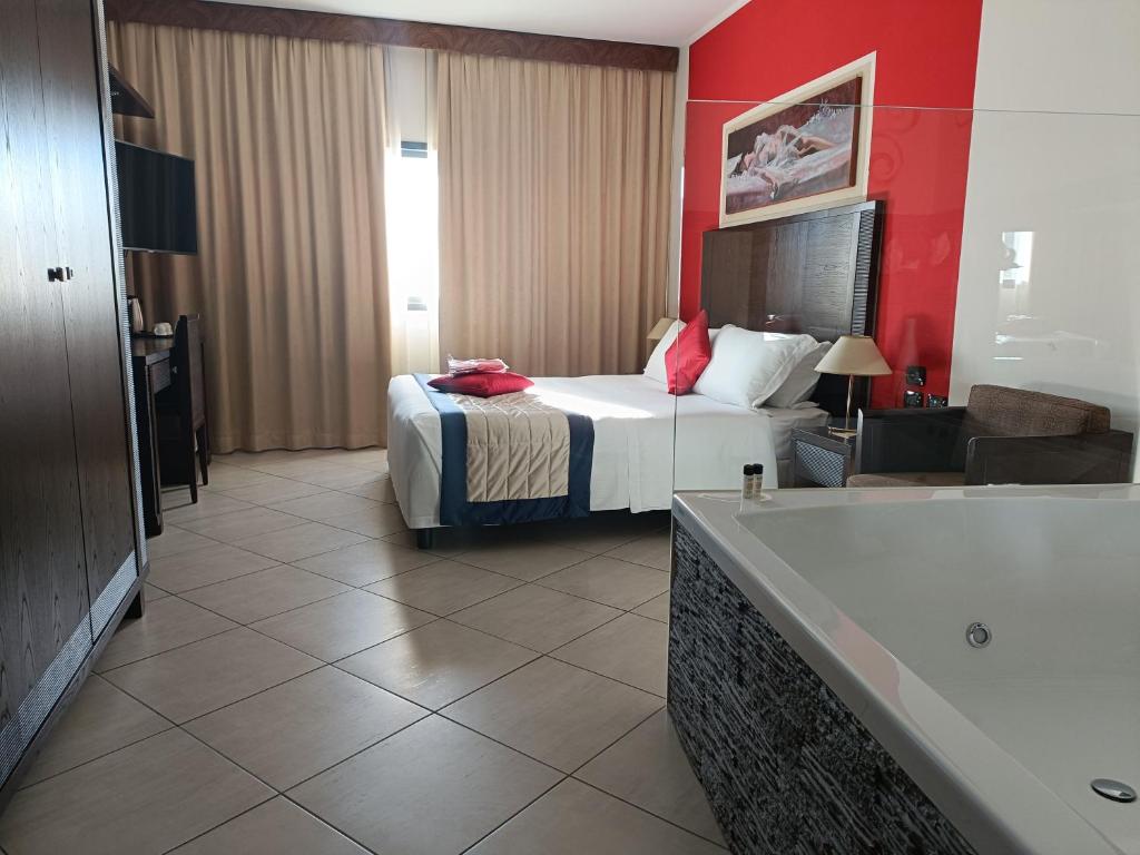 Postel nebo postele na pokoji v ubytování Green Hotel Ninfa