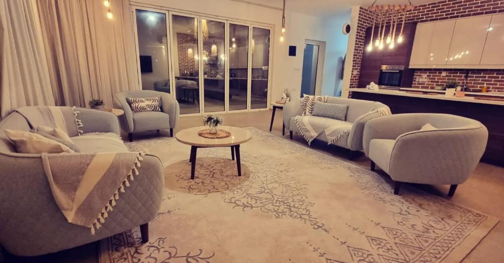 ein großes Wohnzimmer mit Sofas und einem Tisch in der Unterkunft My Resort in Al Rahba