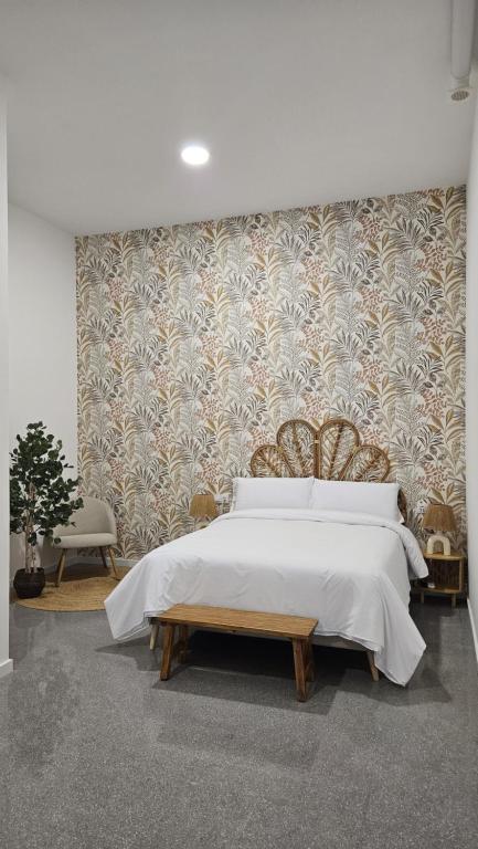 a bedroom with a large bed and a wall at Imperial Apartamentos Puerto in Valencia