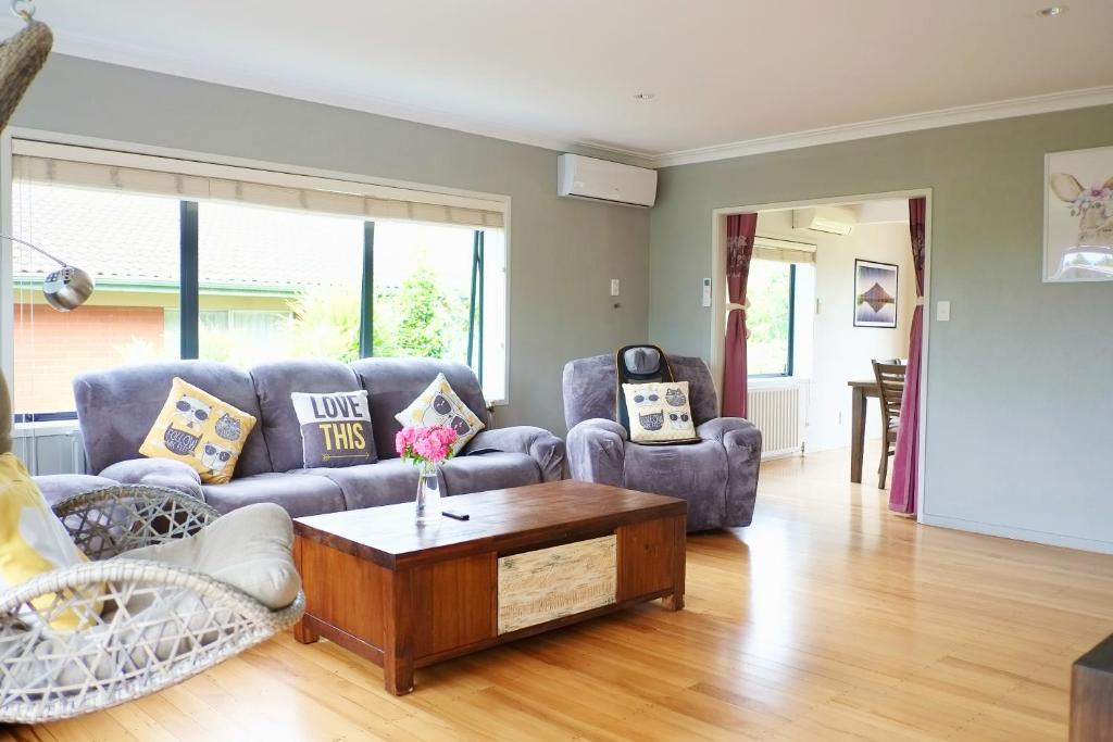 a living room with a couch and a coffee table at Wylie 5 Bedrooms house in Rotorua