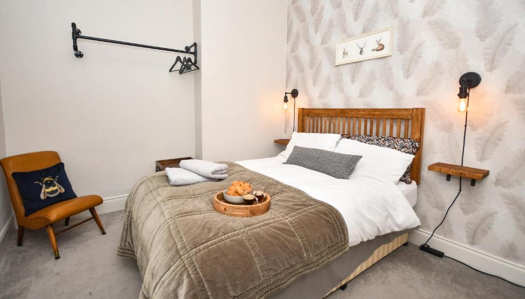 a bedroom with a bed and a chair at The Cranny 2 Bed House in Central Morpeth in Morpeth