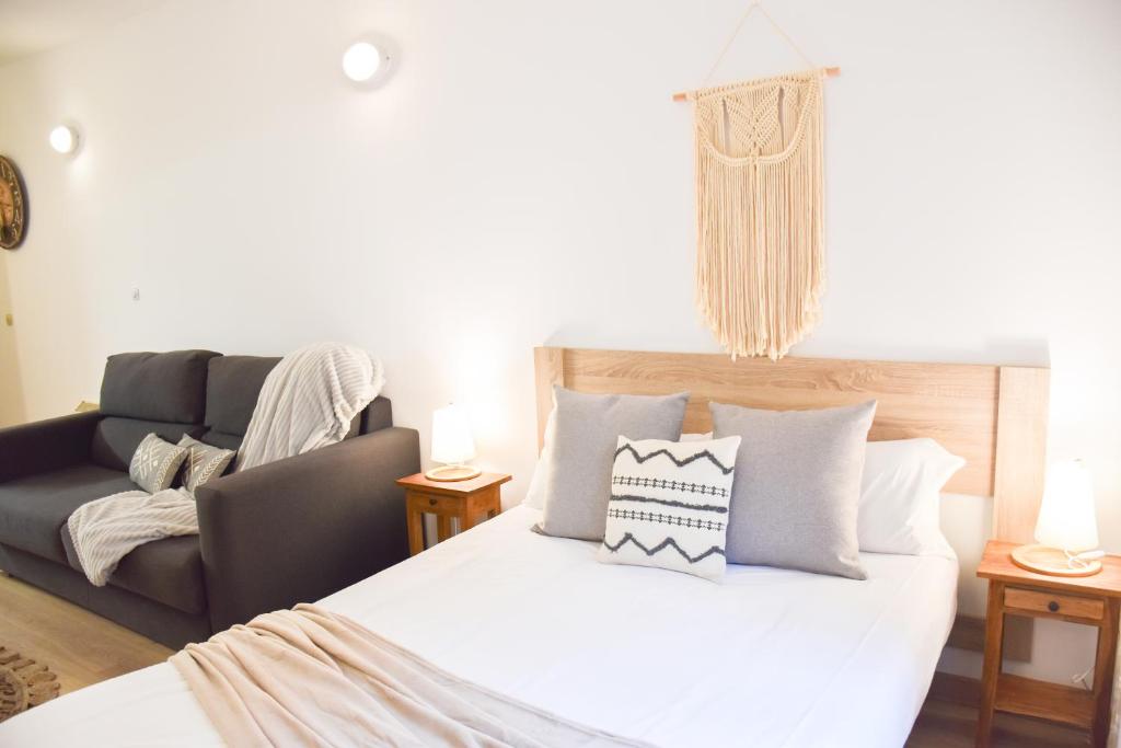 a bedroom with a bed and a couch at La Neu I Studio Pas de Casa HUT2-8055 in Pas de la Casa
