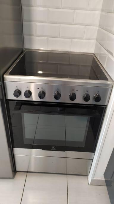 a stove top oven sitting in a kitchen at T2 de 42m² A proximité de la gare à 30min de PARIS in Mantes-la-Jolie