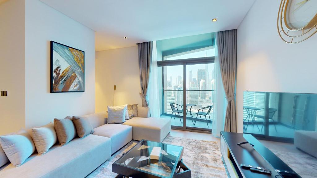 a living room with a couch and a table at Primestay - 15 Northside 2BR in Business Bay in Dubai