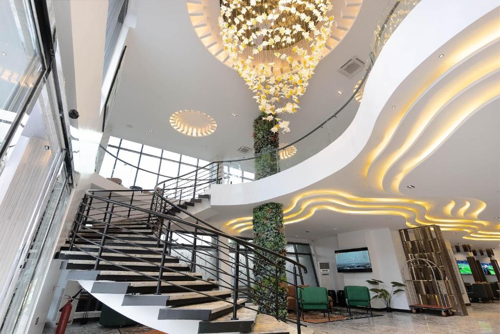 a spiral staircase in a building with a chandelier at GTA HOTEL IKEJA in Ikeja