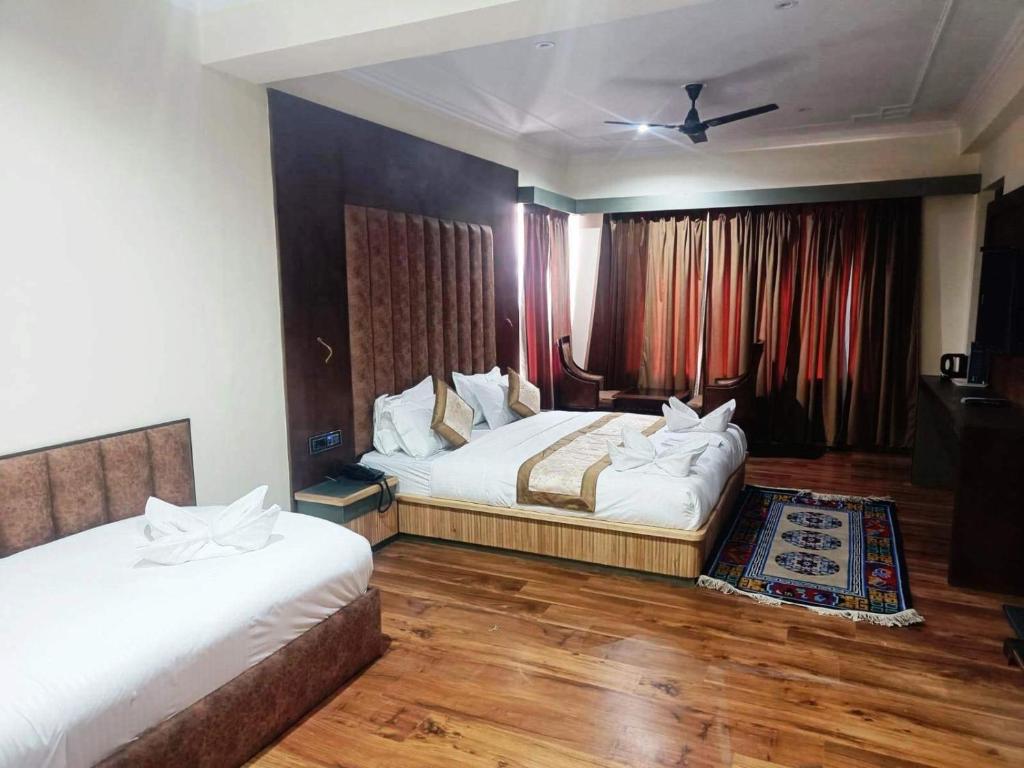 a hotel room with two beds and a window at Hotel Ladakh Heaven in Leh