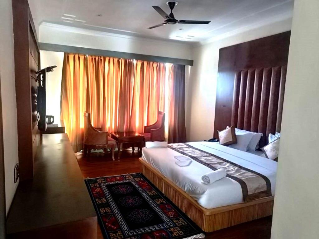a bedroom with a large bed and a window at Hotel Ladakh Heaven in Leh