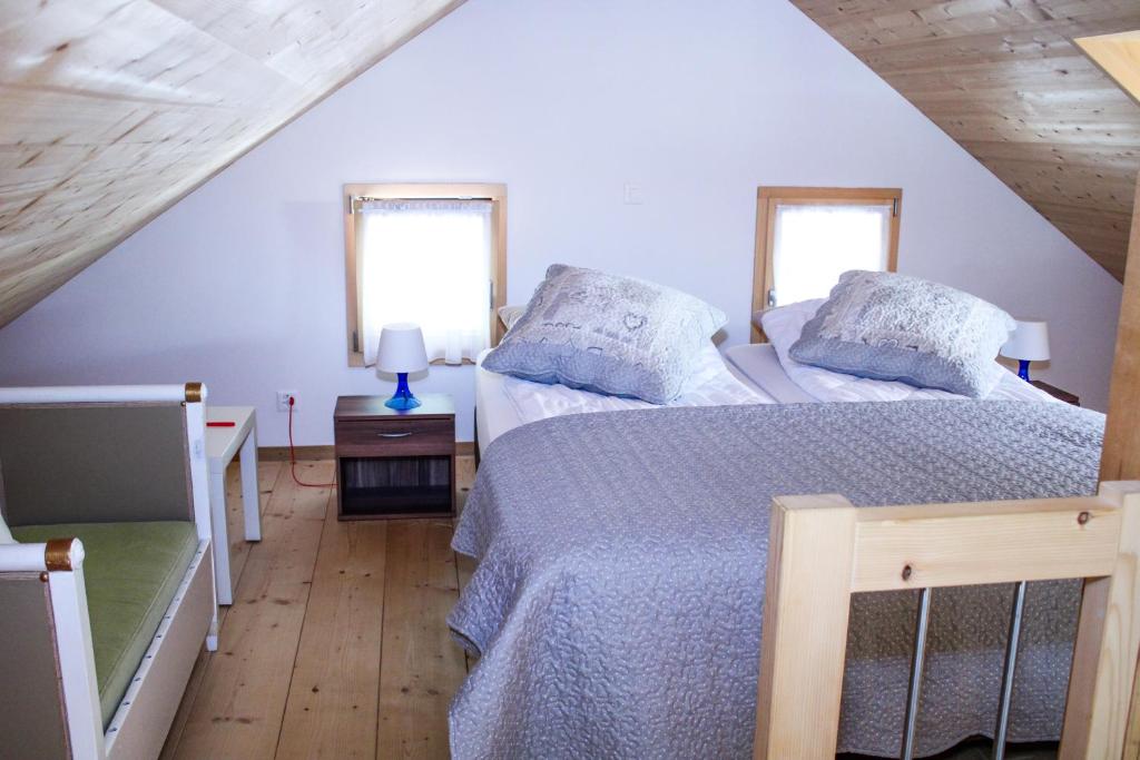 a bedroom with two beds and two windows at Mys Chalet in Jaun