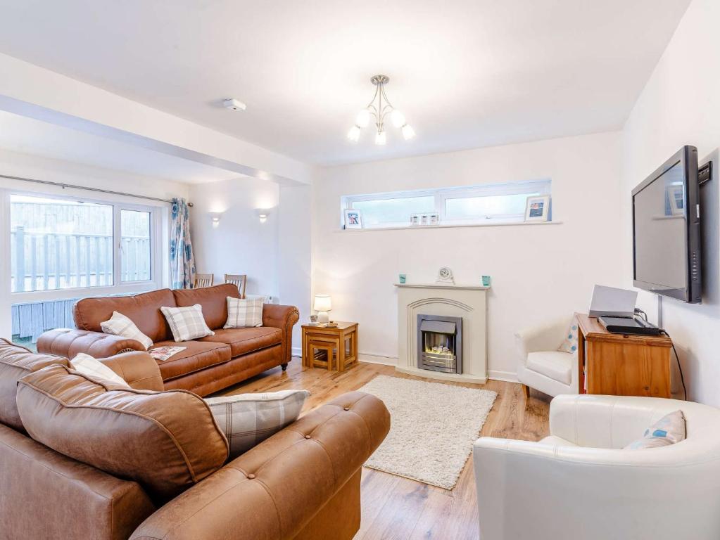 a living room with a couch and a fireplace at 3 Bed in Torquay 82959 in Torquay