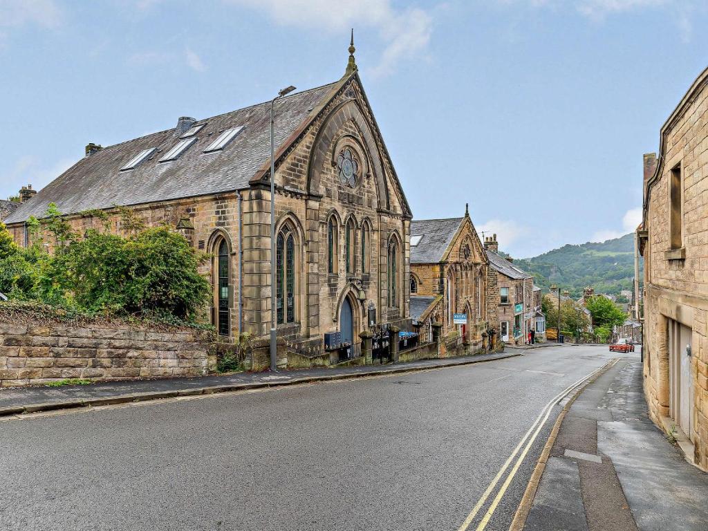 an old stone church on the side of a street at 1 Bed in Matlock 85176 in Matlock