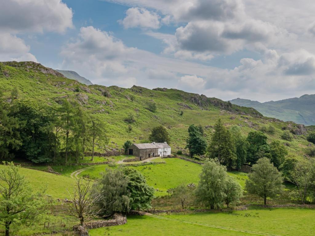 an old house on a hill in a green field at 3 Bed in Duddon Valley SZ107 in Eskdale