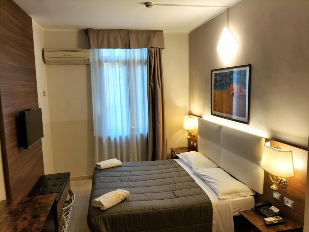Postel nebo postele na pokoji v ubytování Hotel MM Dateo