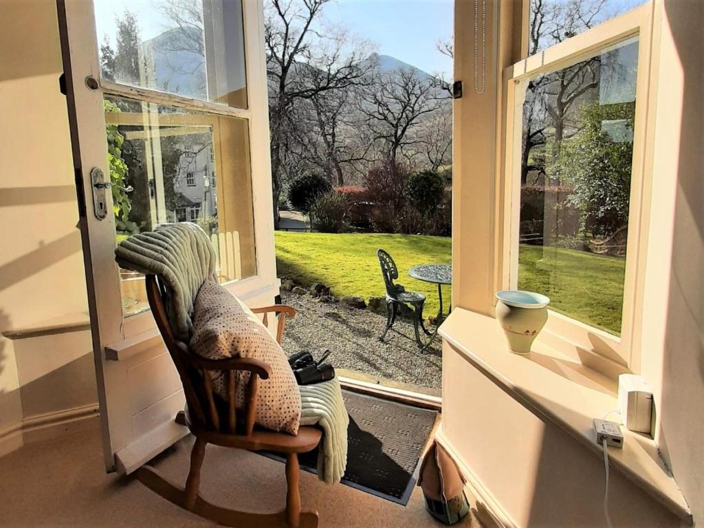 a room with a chair and an open door at 1 bed property in Keswick 86117 in Braithwaite