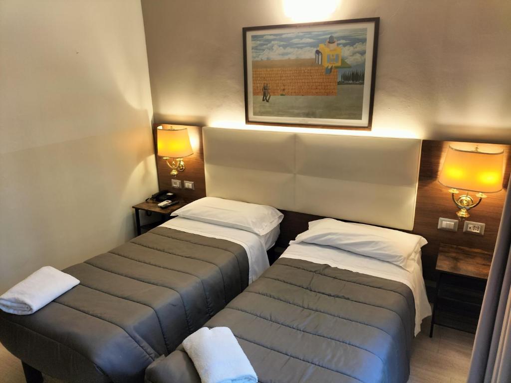 Postel nebo postele na pokoji v ubytování Hotel MM Dateo