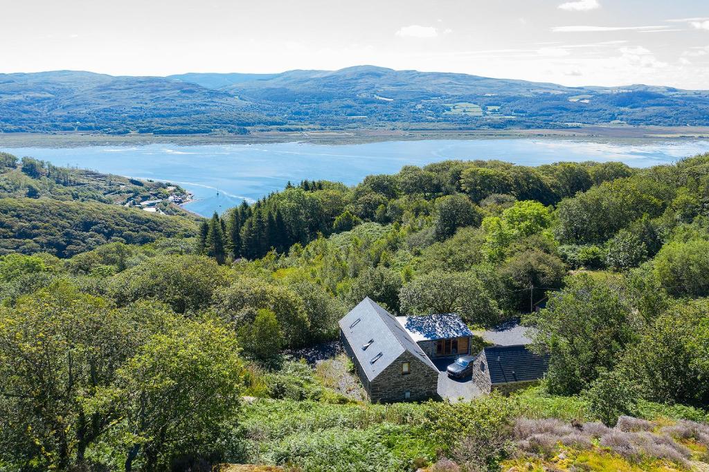 an aerial view of a house on a hill with a lake at 3 Bed in Aberdovey DY033 in Aberdyfi