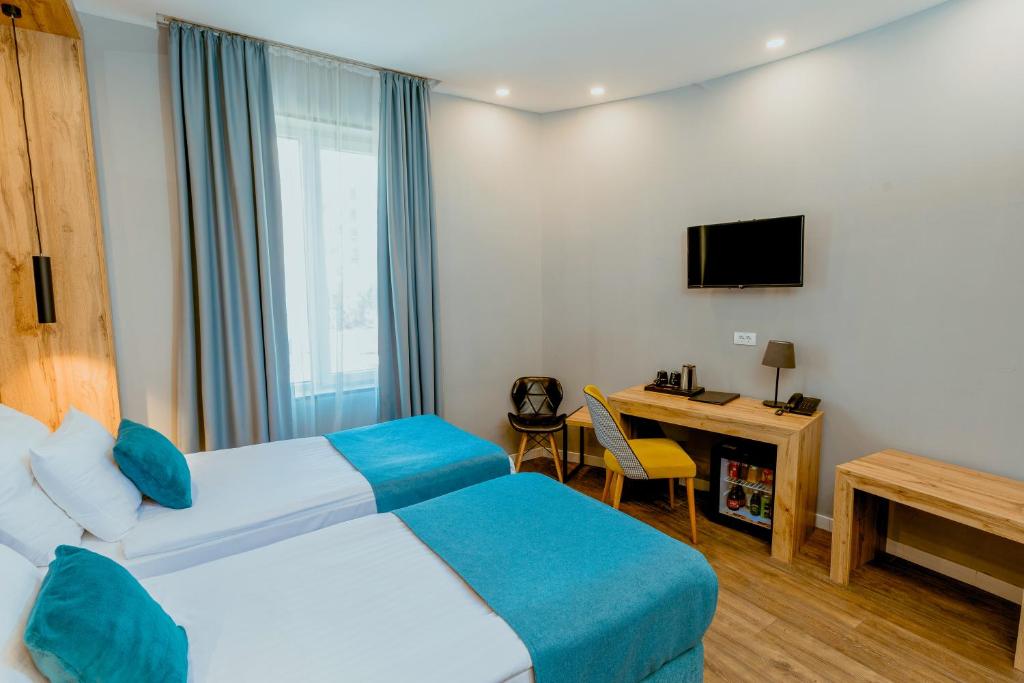 Krevet ili kreveti u jedinici u okviru objekta Nobel Gallery Hotel
