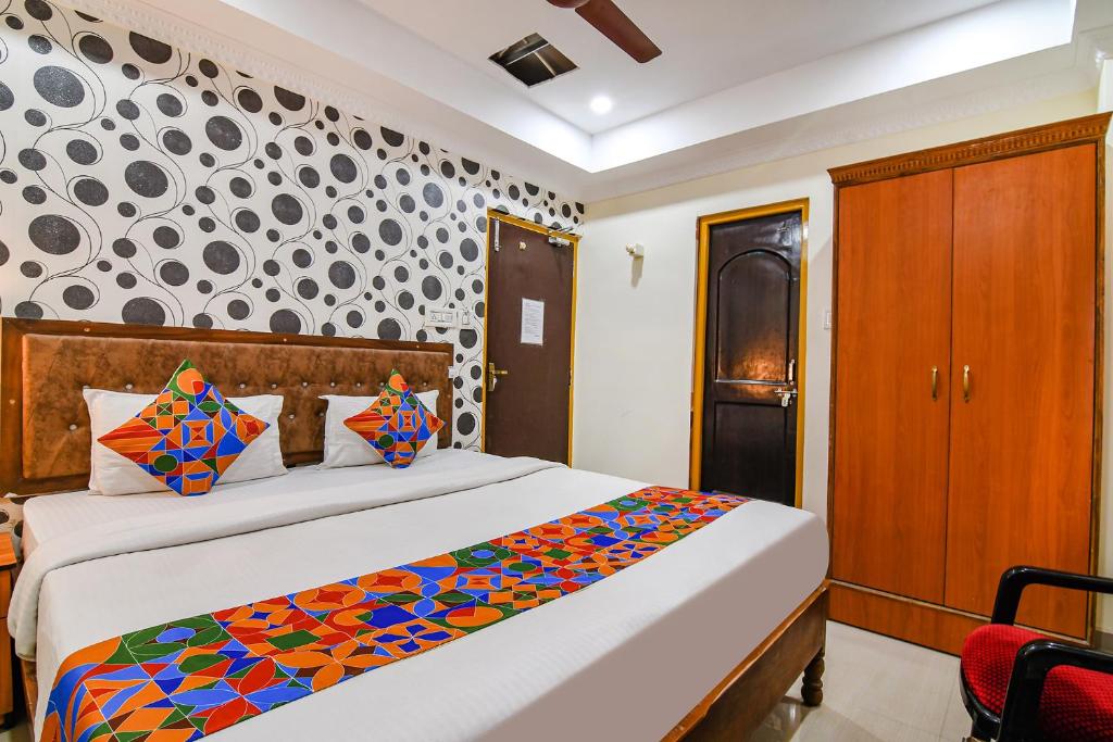 a bedroom with a bed with a colorful blanket at FabHotel Sagar Royale in Bhubaneshwar