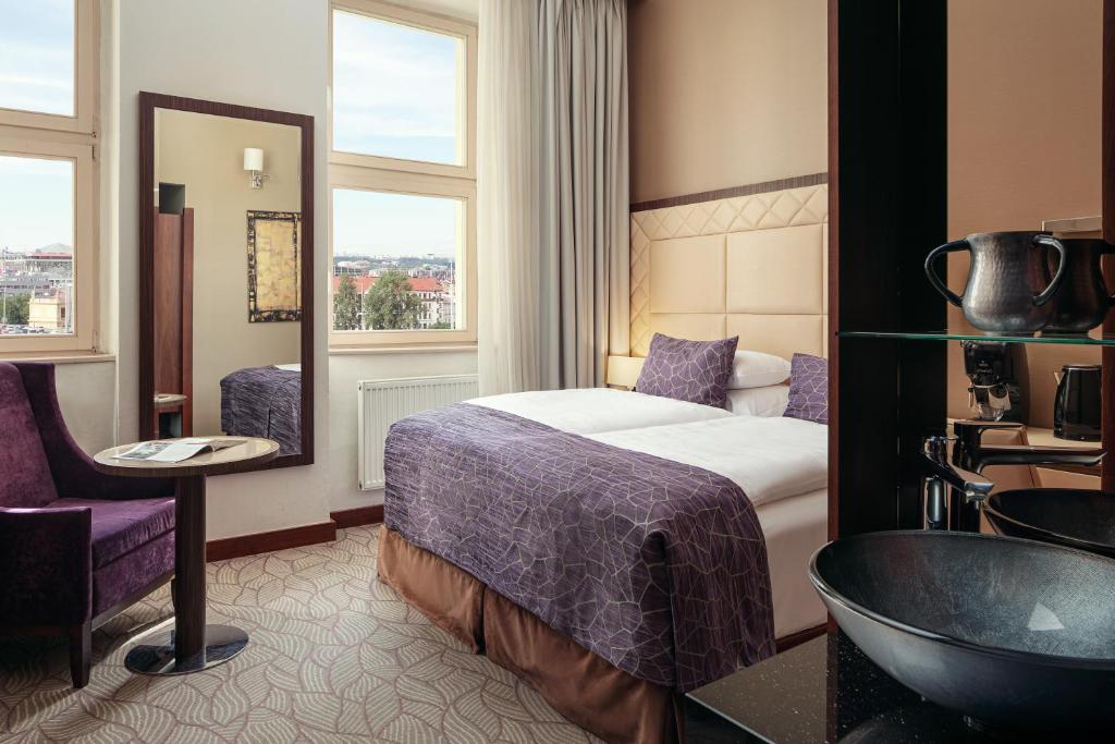 a hotel room with a bed and a bathroom at Kosher Hotel King David Prague in Prague