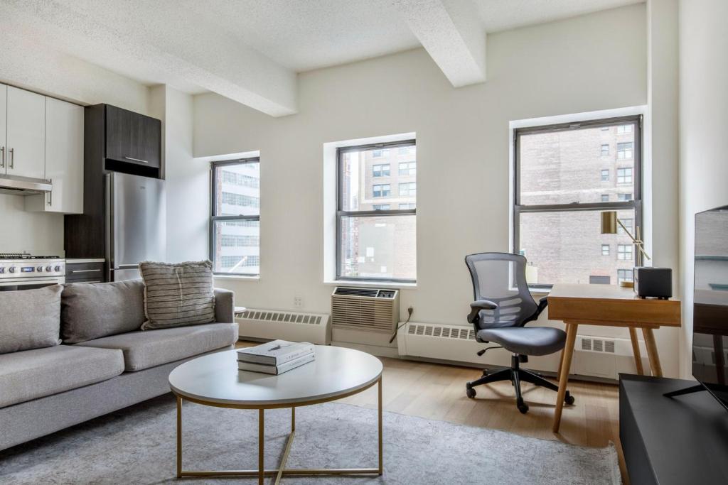 a living room with a couch and a table at Hudson Yards 1br w gym wd nr penn station NYC-1308 in New York