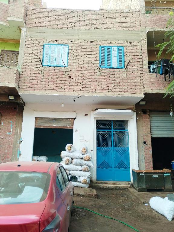 a red car parked in front of a brick building at منزل سيد سعد in Cairo