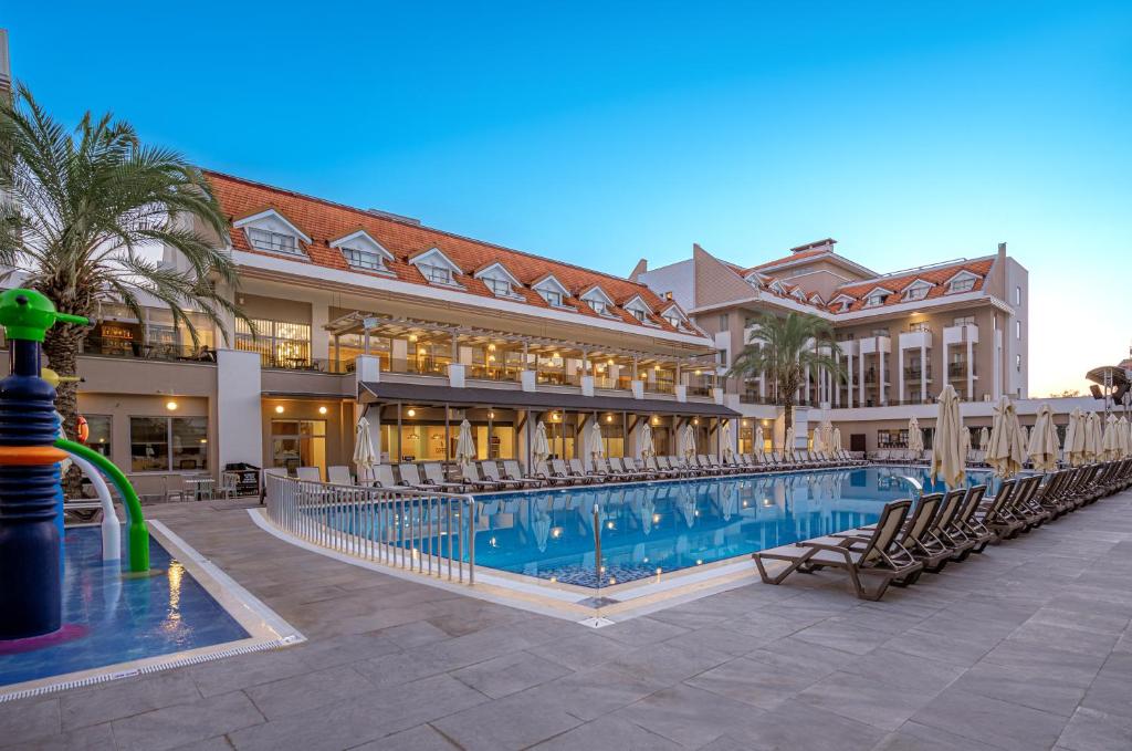 a resort with a swimming pool in front of a building at Side Story Resort & Spa in Side