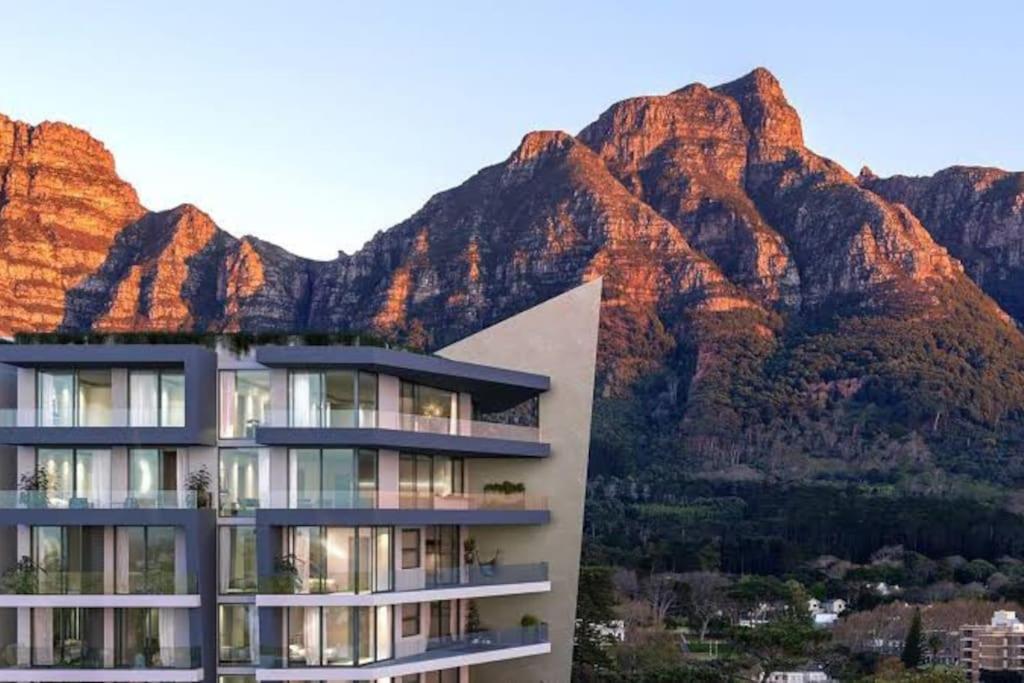 a building with a mountain in the background at Luxury apartment in Newlands in Cape Town
