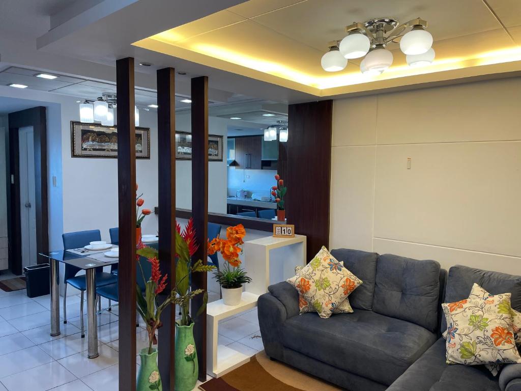 a living room with a couch and a table at Cozy 2-bedroom Condo at Marcos Highway in Manila