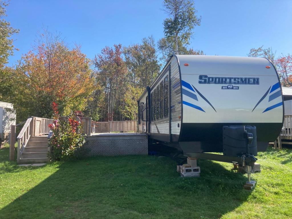 a truck parked in a yard with a fence at Cavendish Luxury Camping in Cavendish