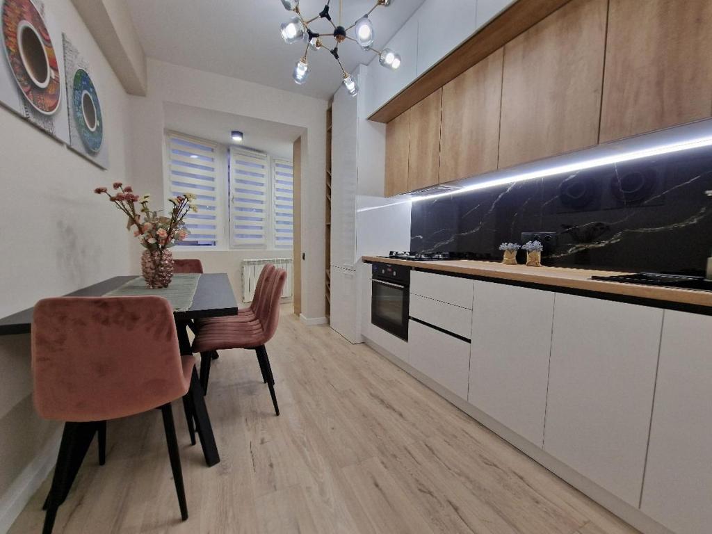 a kitchen with a table and a dining room at KSY Hotel Family Stay in Tbilisi City