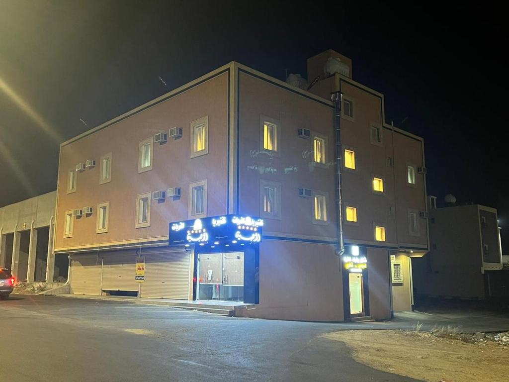 a large building with lights on it at night at شقق ثمانين بارك1 in Khamis Mushayt