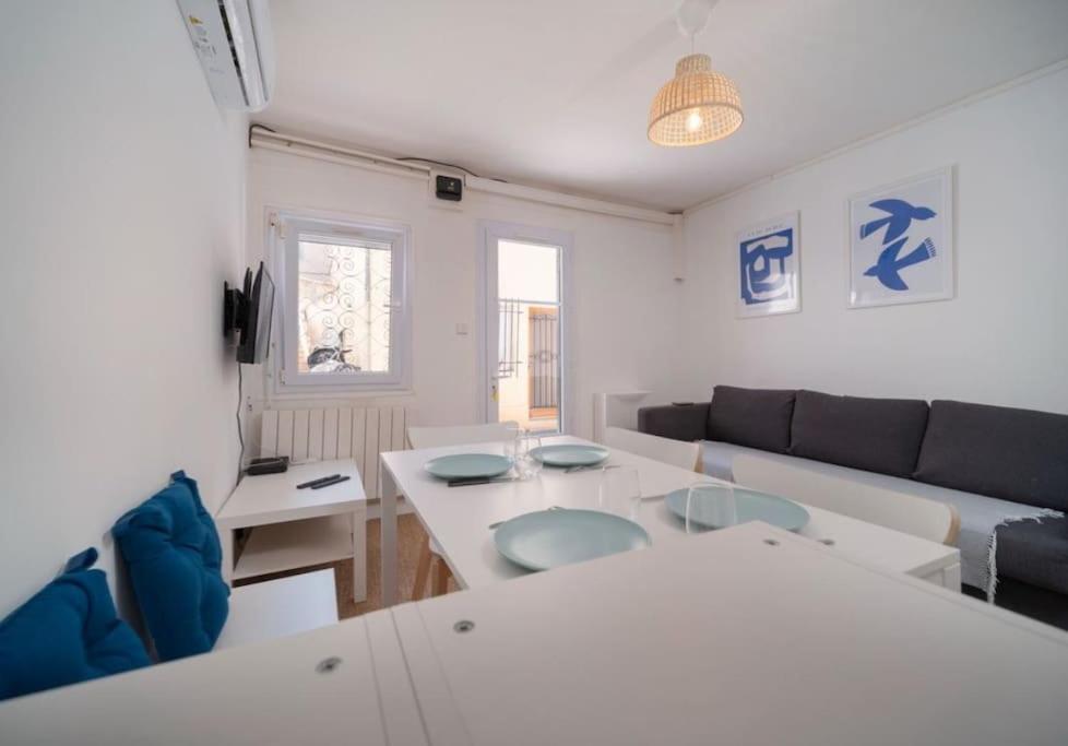 ein Wohnzimmer mit einem Sofa und einem Tisch in der Unterkunft Maison au cœur de l’Estaque in Marseille