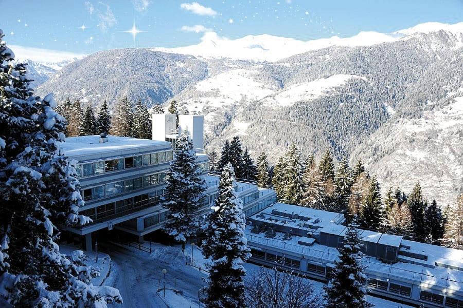 a building on top of a snow covered mountain at Appartamento Marilleva1400 residence Albarè in Marilleva