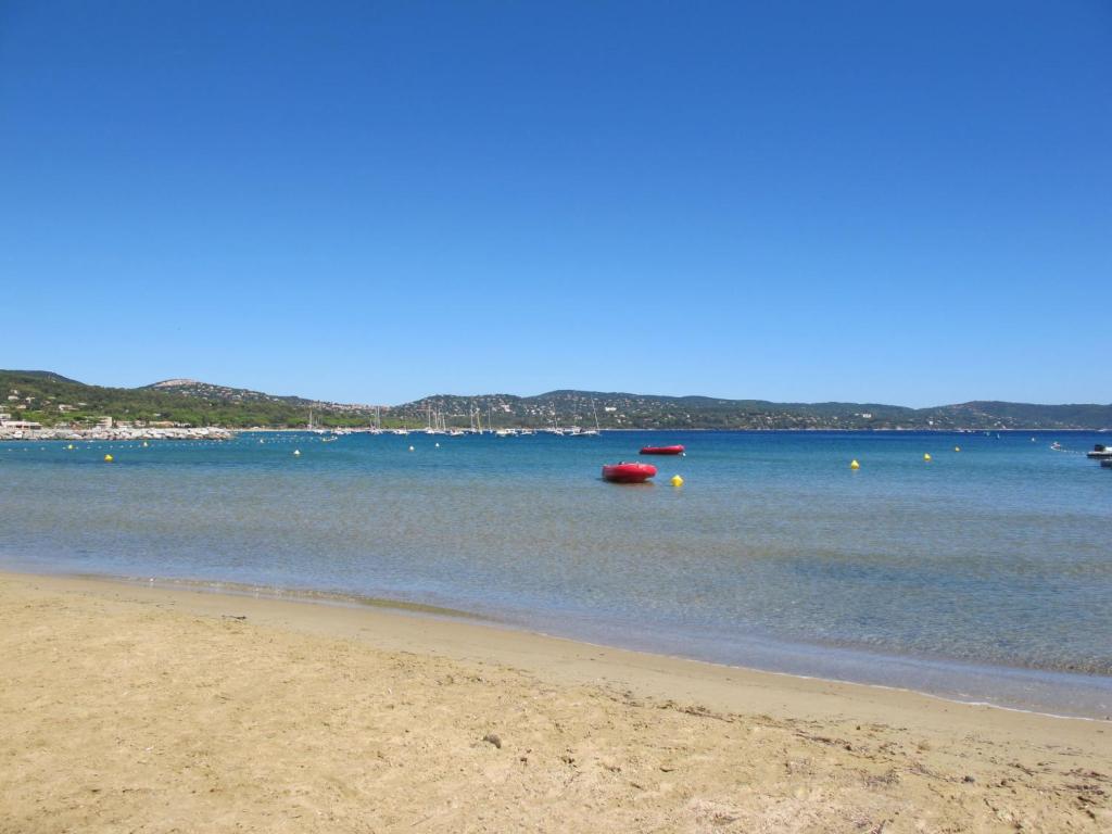 a sandy beach with boats in the water at Apartment Turquoise-10 by Interhome in Cavalaire-sur-Mer