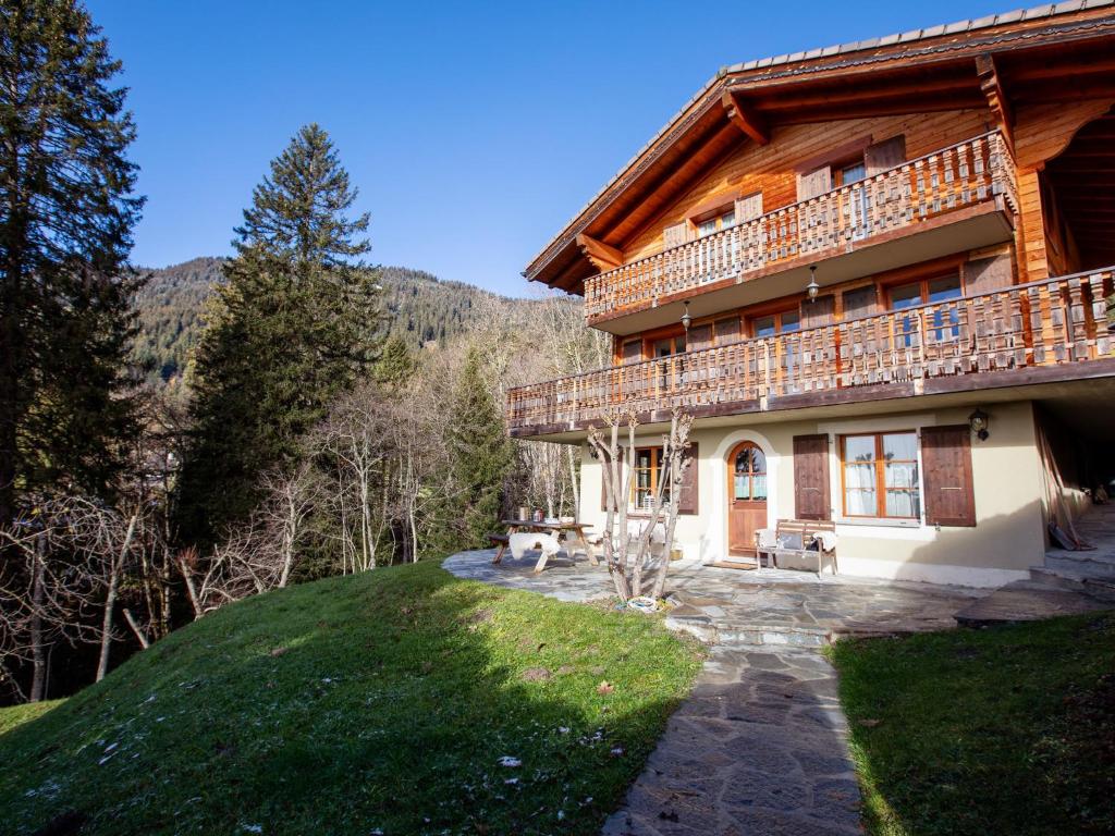a log house with a balcony on the side of it at Chalet Chalet Tetras by Interhome in Chesières