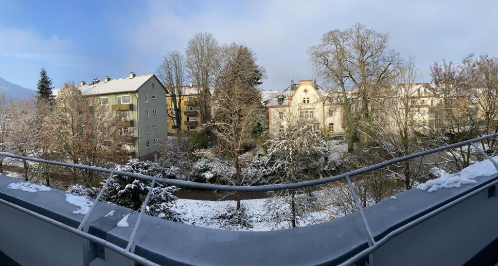 a view of a city in the snow from a balcony at Gemütliches Galerie Apartment in Bad Säckingen