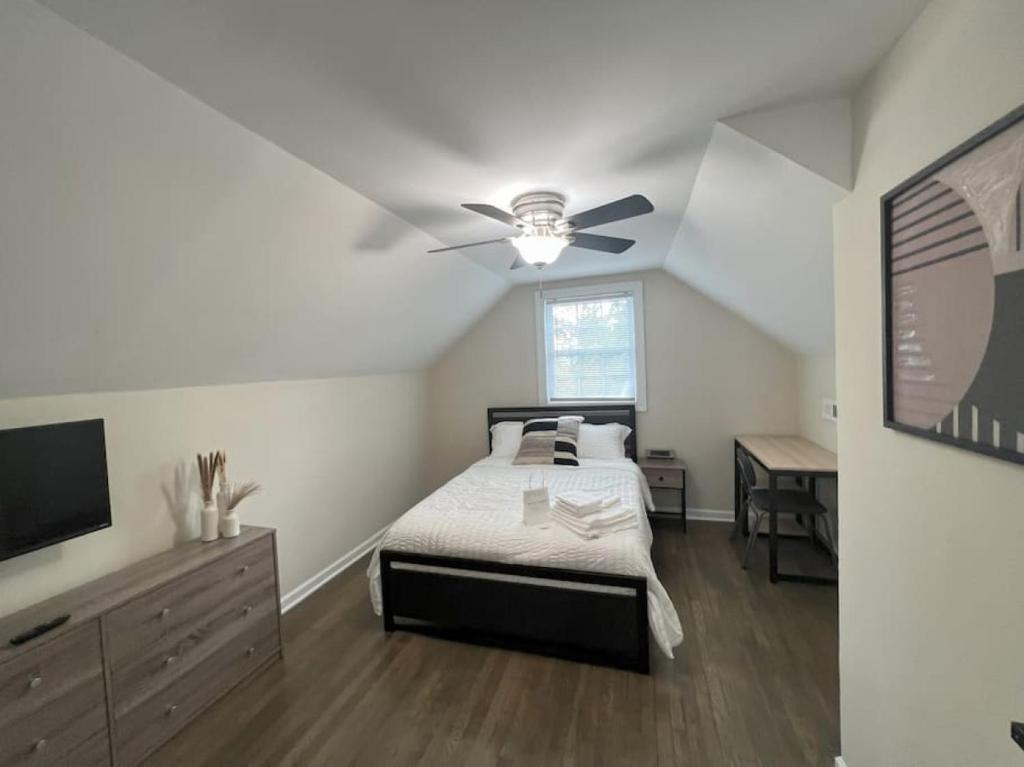 a bedroom with a bed and a ceiling fan at The Castilian by Keywee Rentals in Manassas