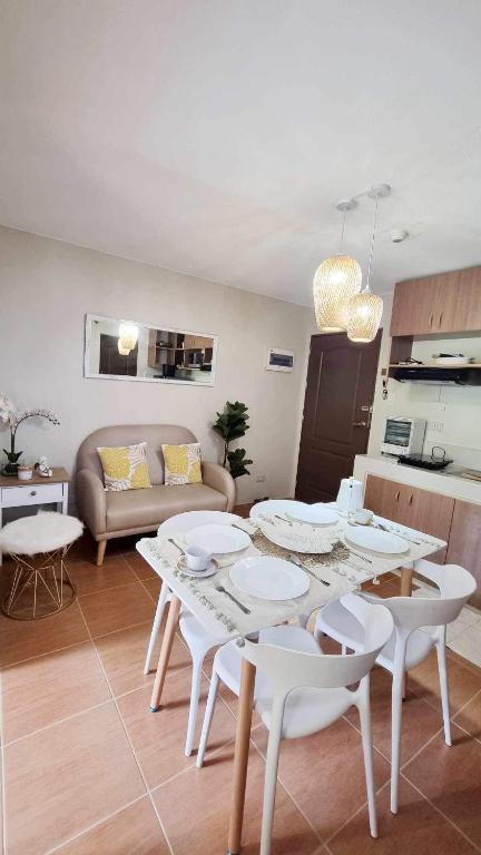 a living room with a white table and chairs at 2 Br Condo Unit Cagayan de Oro City in Cagayan de Oro