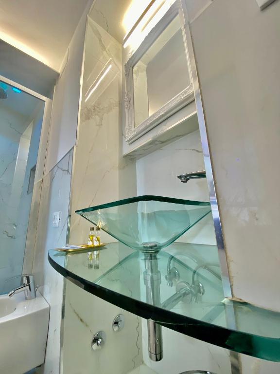 a glass counter in a bathroom with a sink at The Manarola Main Plaza in Manarola