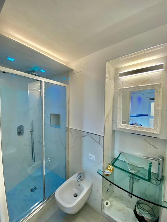 a bathroom with a glass shower and a sink at The Manarola Main Plaza in Manarola